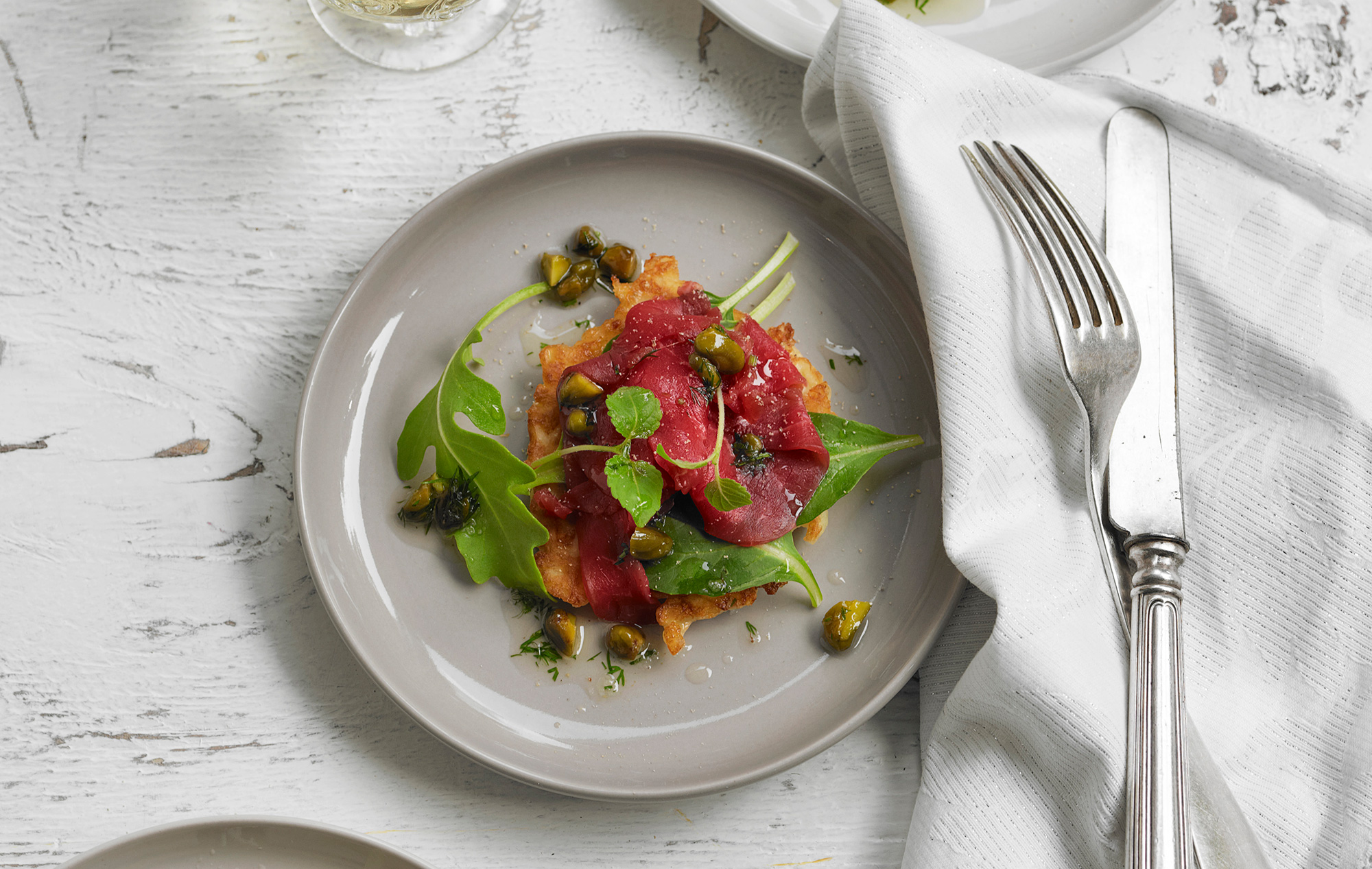 Aardappelblini met carpaccio